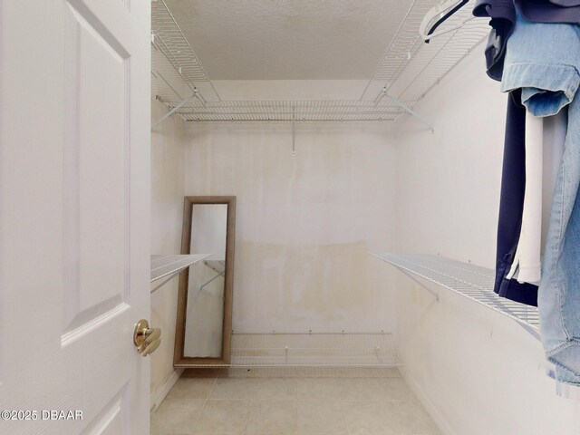 walk in closet featuring light tile patterned floors