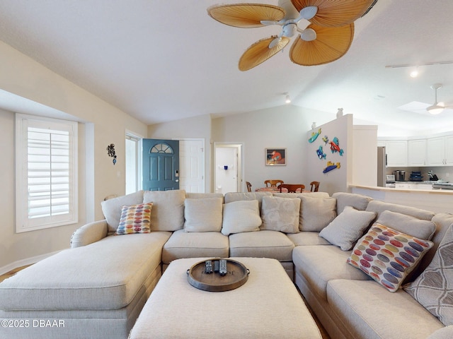 living room featuring vaulted ceiling and ceiling fan