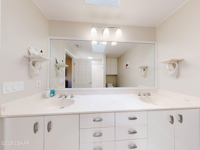 bathroom with vanity, a shower with curtain, a textured ceiling, and toilet