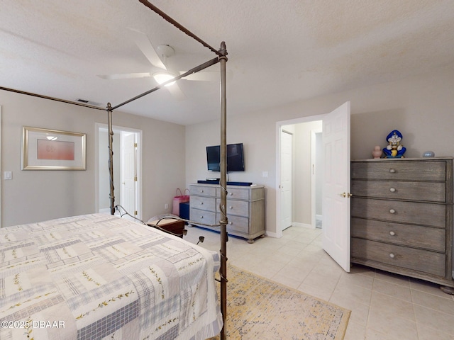 tiled bedroom with a textured ceiling and ceiling fan