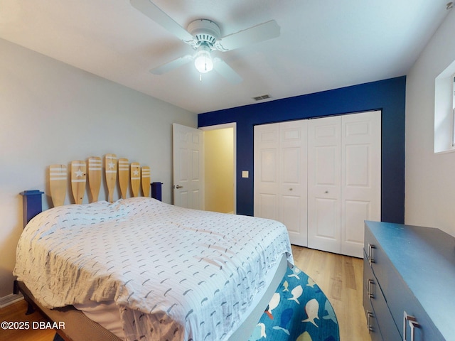 bedroom with a closet, ceiling fan, and light wood-type flooring