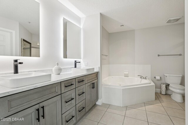 4650 Links Village Dr Unit B103, Ponce Inlet, FL 32127 - bathroom featuring double vanity, a tub with jets, and tile patterned floors