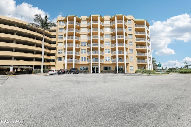 4650 Links Village Dr Unit B103, Ponce Inlet, FL 32127 - view of apartment building / complex featuring uncovered parking