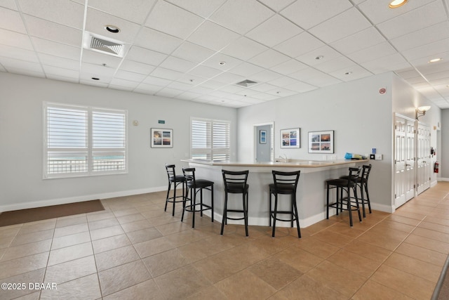 4650 Links Village Dr Unit B103, Ponce Inlet, FL 32127 - kitchen with tile patterned floors, a paneled ceiling, a kitchen breakfast bar, a peninsula, and recessed lighting
