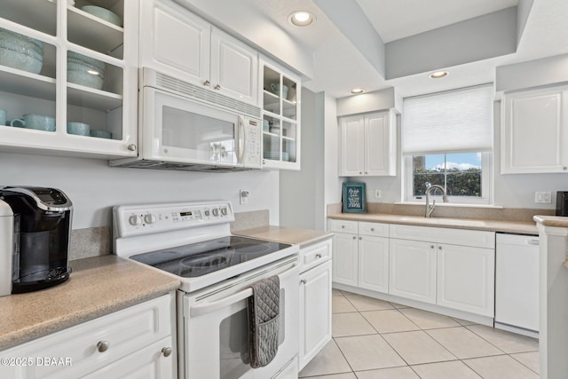 4650 Links Village Dr Unit B103, Ponce Inlet, FL 32127 - kitchen featuring white appliances, glass insert cabinets, light tile patterned flooring, light countertops, and recessed lighting