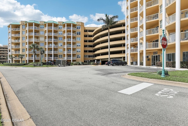 4650 Links Village Dr Unit B103, Ponce Inlet, FL 32127 - view of apartment building / complex featuring uncovered parking