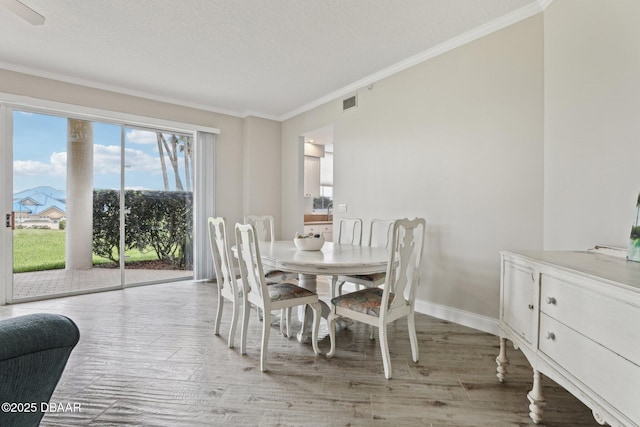 4650 Links Village Dr Unit B103, Ponce Inlet, FL 32127 - dining area featuring ornamental molding and light wood-style floors
