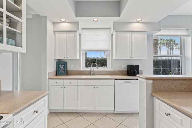4650 Links Village Dr Unit B103, Ponce Inlet, FL 32127 - kitchen with white dishwasher, light tile patterned flooring, and white cabinetry