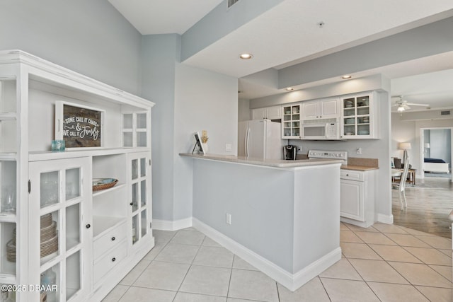 4650 Links Village Dr Unit B103, Ponce Inlet, FL 32127 - kitchen with white appliances, light tile patterned floors, white cabinetry, glass insert cabinets, and recessed lighting