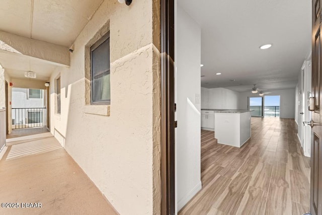 3807 S Atlantic Ave Unit 2020, Daytona Beach, FL 32118 - hallway with a textured wall, recessed lighting, and light wood-type flooring