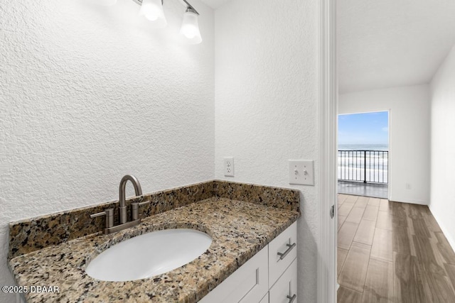 3807 S Atlantic Ave Unit 2020, Daytona Beach, FL 32118 - bathroom with a textured wall, vanity, and a water view