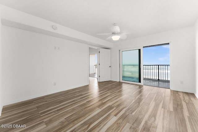 3807 S Atlantic Ave Unit 2020, Daytona Beach, FL 32118 - empty room with wood finished floors, a ceiling fan, and a smoke detector