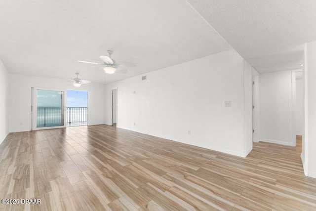 3807 S Atlantic Ave Unit 2020, Daytona Beach, FL 32118 - unfurnished room with light wood-type flooring and ceiling fan