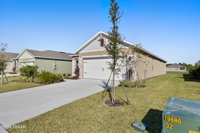 view of side of home with a lawn and a garage