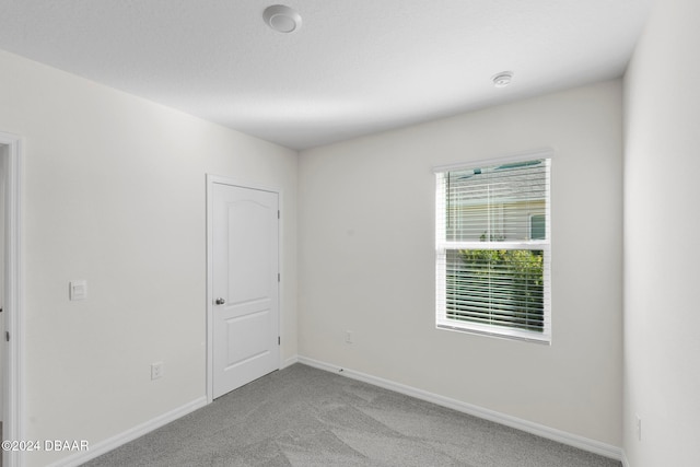 unfurnished room with light colored carpet