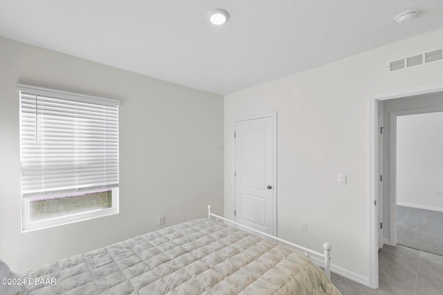 unfurnished bedroom featuring light colored carpet