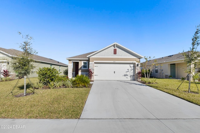 view of front of property with a garage and a front yard