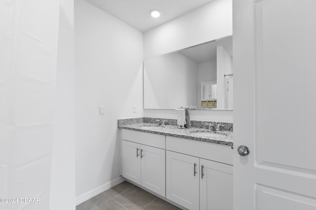 bathroom featuring tile patterned flooring and vanity