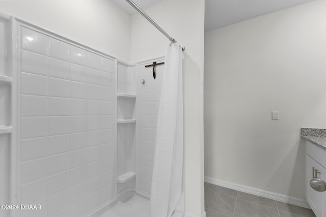 bathroom with tile patterned flooring, a shower with curtain, and vanity