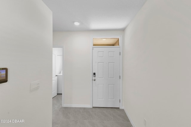 hall featuring light tile patterned floors