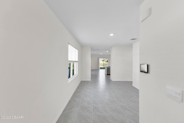 corridor with light tile patterned floors