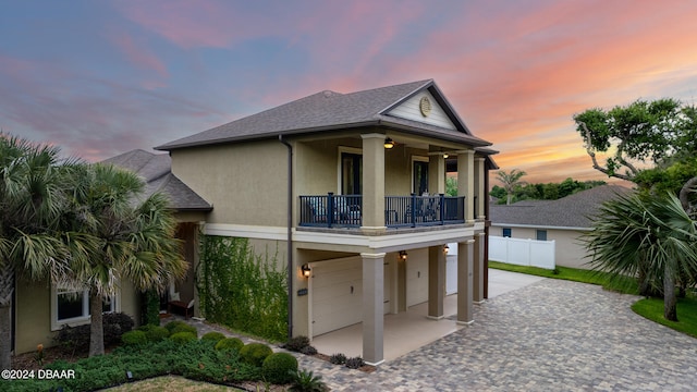 view of front of home featuring a garage and a balcony