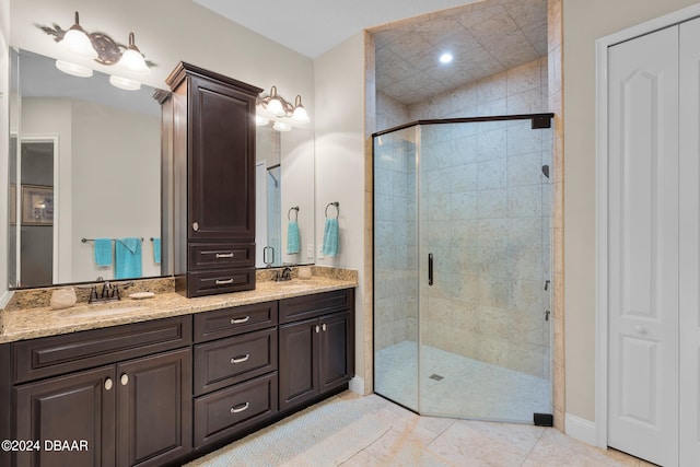 bathroom with tile patterned flooring, vanity, and an enclosed shower