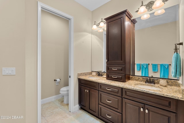 bathroom with tile patterned flooring, vanity, and toilet