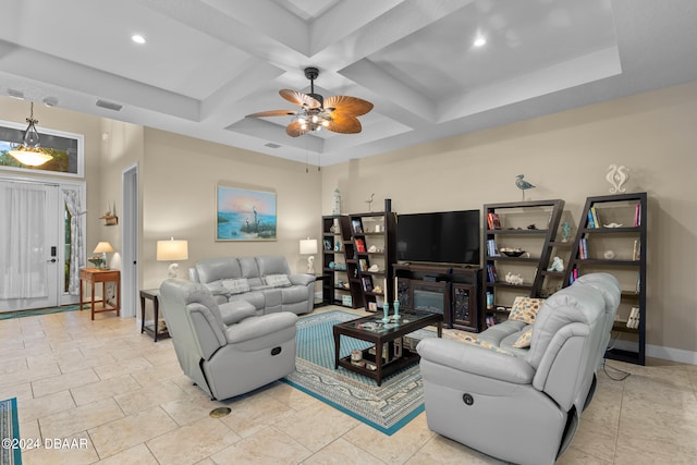 living room with coffered ceiling, ceiling fan, light tile patterned floors, beamed ceiling, and a fireplace