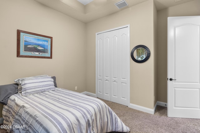 carpeted bedroom featuring a closet