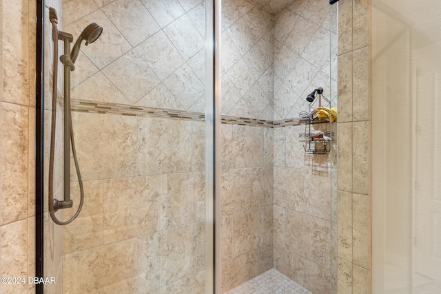 bathroom with a shower with door