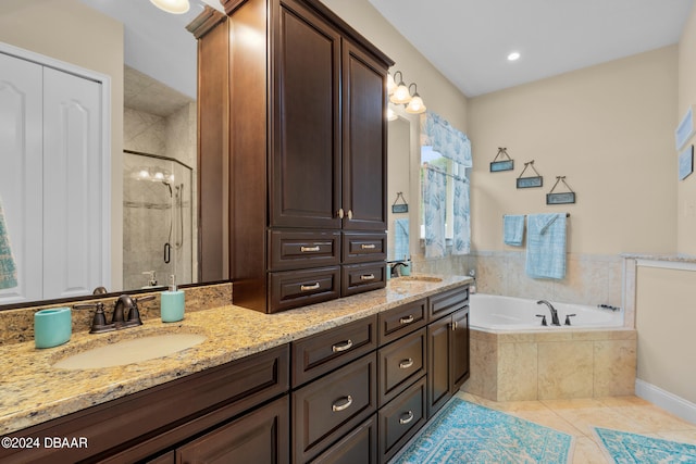 bathroom featuring tile patterned flooring, shower with separate bathtub, and vanity