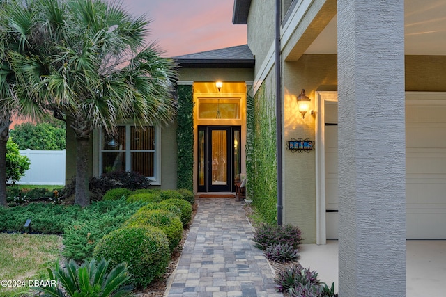 view of exterior entry at dusk