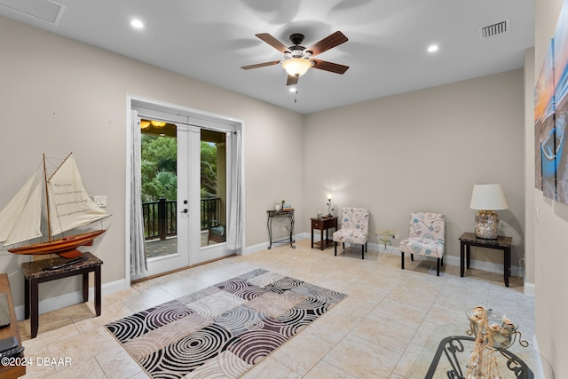 living area with ceiling fan and french doors