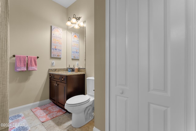 bathroom with tile patterned flooring, vanity, and toilet