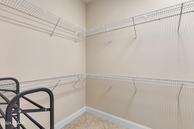 spacious closet featuring light tile patterned floors