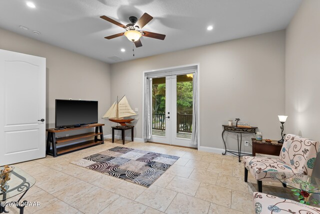 sitting room featuring french doors and ceiling fan