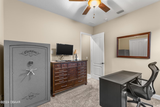 carpeted office space featuring ceiling fan