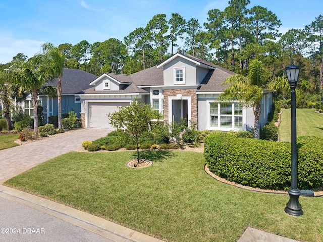 view of front facade with a garage and a front lawn