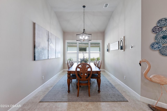 dining area featuring lofted ceiling and a chandelier