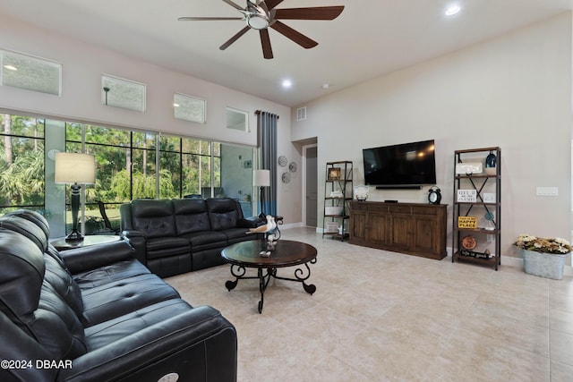 tiled living room featuring a towering ceiling and ceiling fan