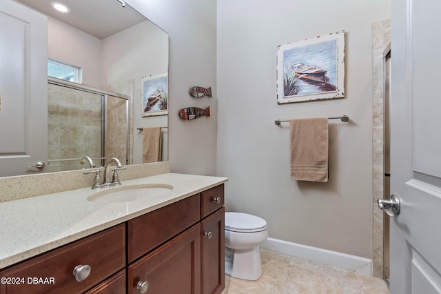 bathroom with vanity, tile patterned floors, toilet, and walk in shower