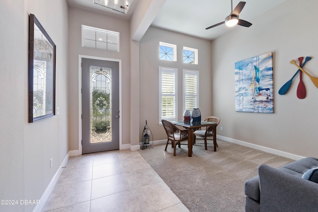 entrance foyer featuring light carpet and ceiling fan