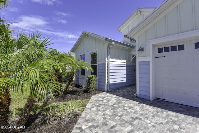 786 Jollymon Way, Daytona Beach, FL 32124 - view of side of home with board and batten siding and an attached garage