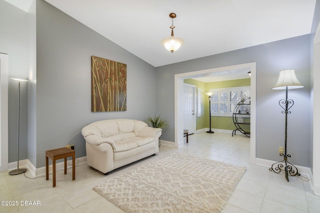 living area featuring lofted ceiling and light tile patterned floors