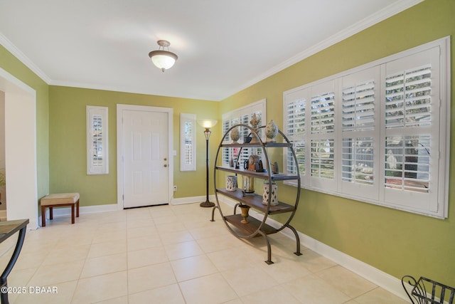 entrance foyer with crown molding and light tile patterned floors