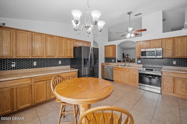 kitchen with backsplash, appliances with stainless steel finishes, sink, and light tile patterned floors