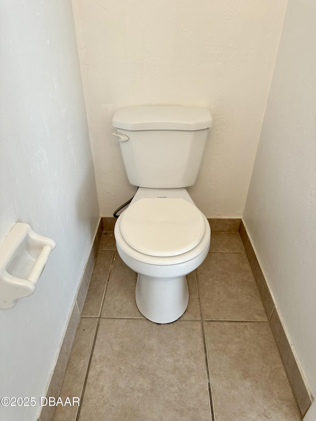 bathroom featuring tile patterned floors and toilet