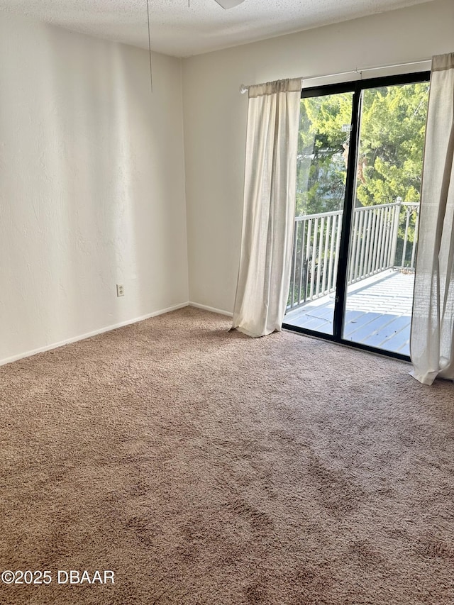 carpeted spare room featuring a textured ceiling