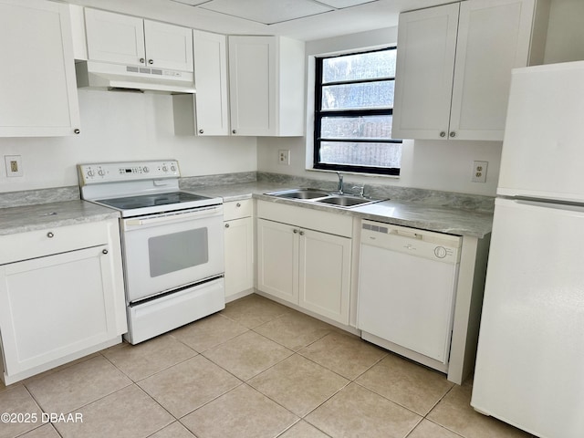 kitchen featuring white appliances, light tile patterned floors, sink, and white cabinets